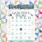Completed Bingo card for a quilt over a completed quilt.