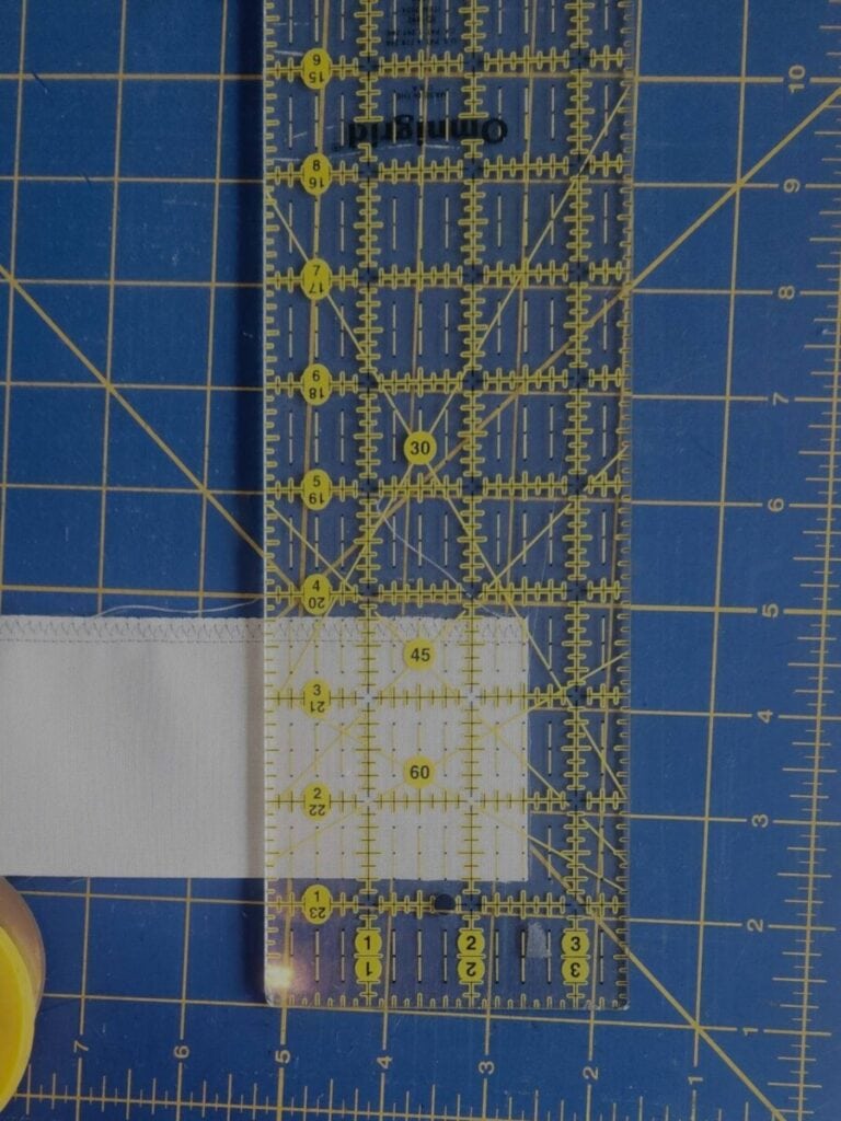Strip of white fabric ready to be cut.