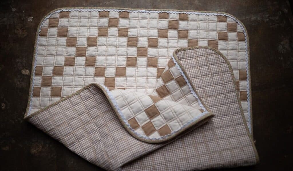 Irish Chain baby quilt crumpled on the floor