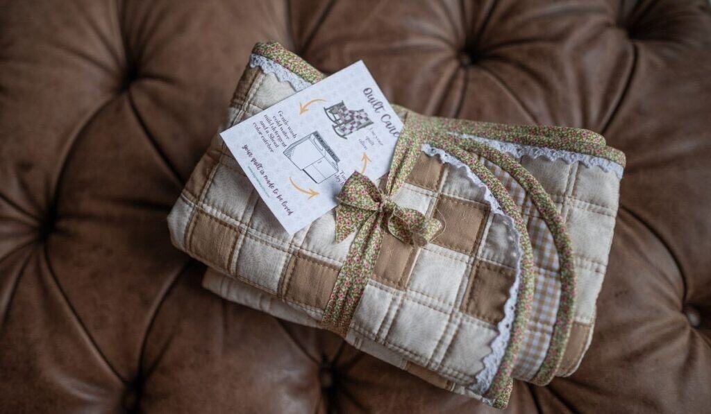 Irish Chain baby quilt folded and wrapped with fabric ribbon ready for gifting