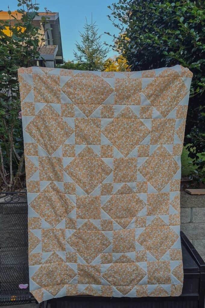 Benedict quilt a scrappy flying geese crib size quilt in peach and off white