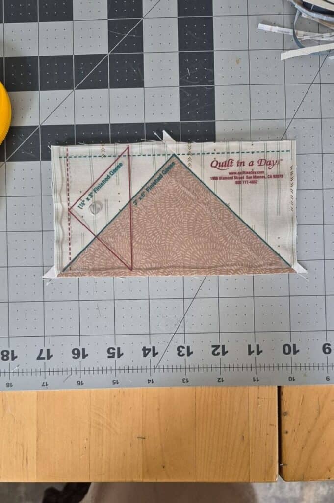 Benedict quilt a single flying geese block under a flying geese ruler
